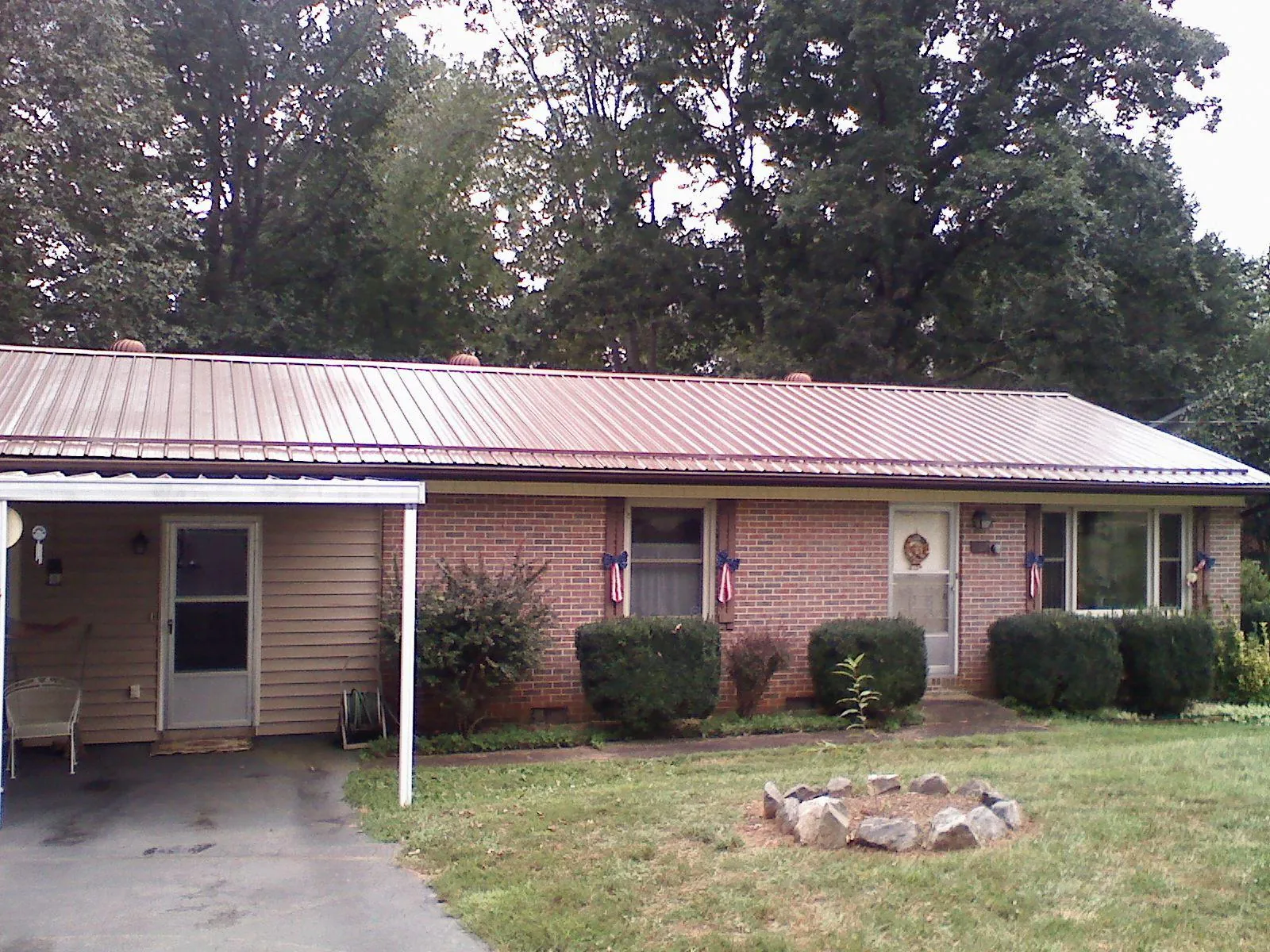Bronze metal roof and carport on a brick ranch home — Roof Repair work by our crew in Red Wing