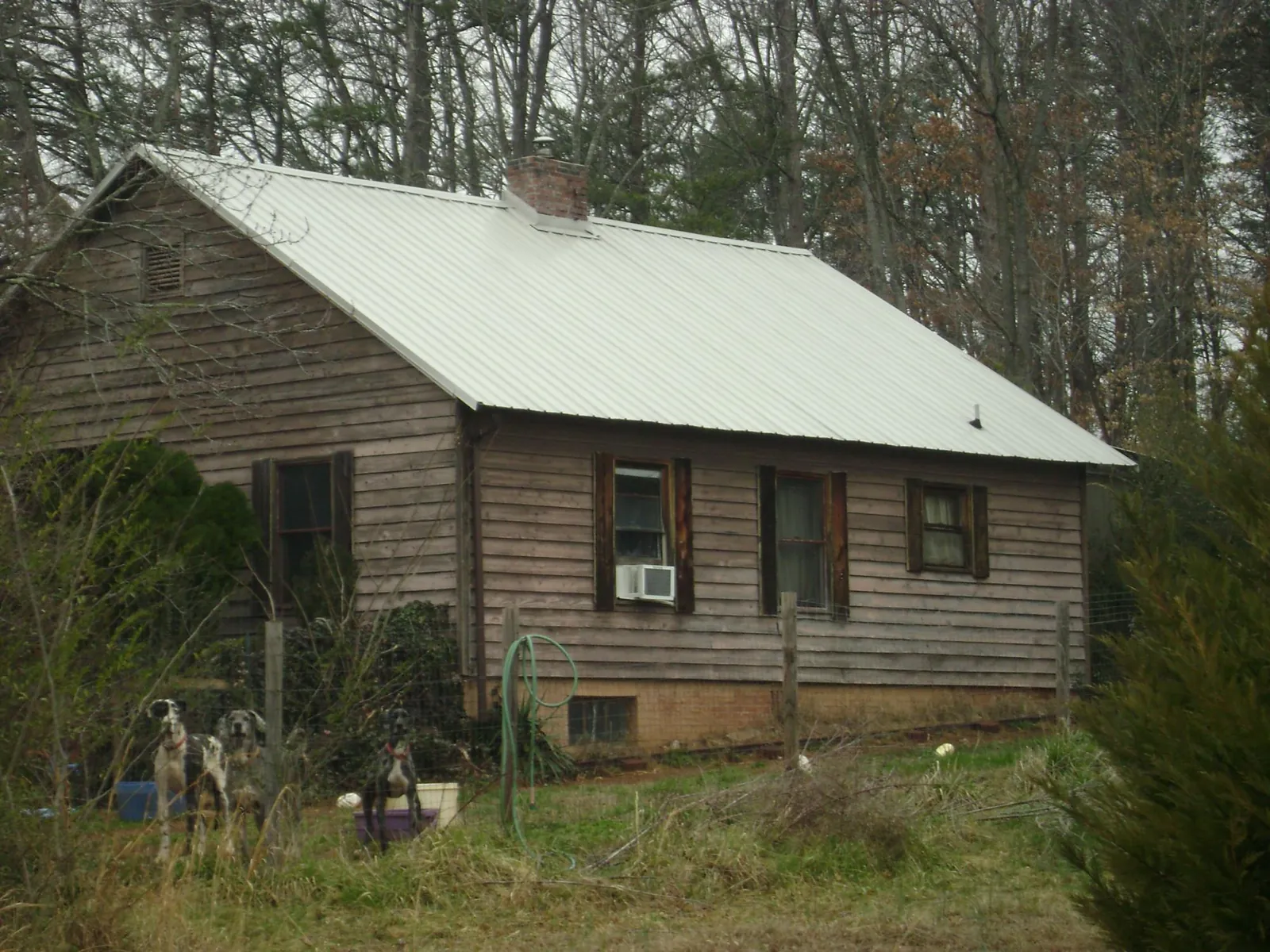 White metal roof on an old wood sided farmhouse, from a Metal Roof Installation job in Red Wing